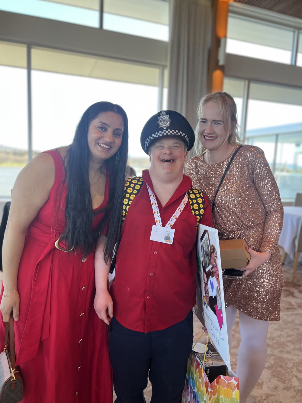 Three people celebrating together indoors at a Focus ACT community event