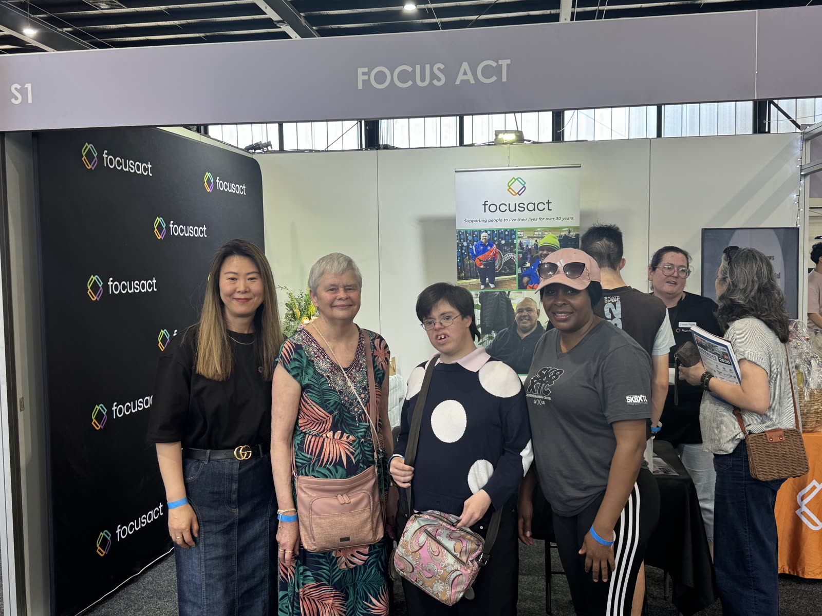 Focus ACT participants and team members together at a community expo