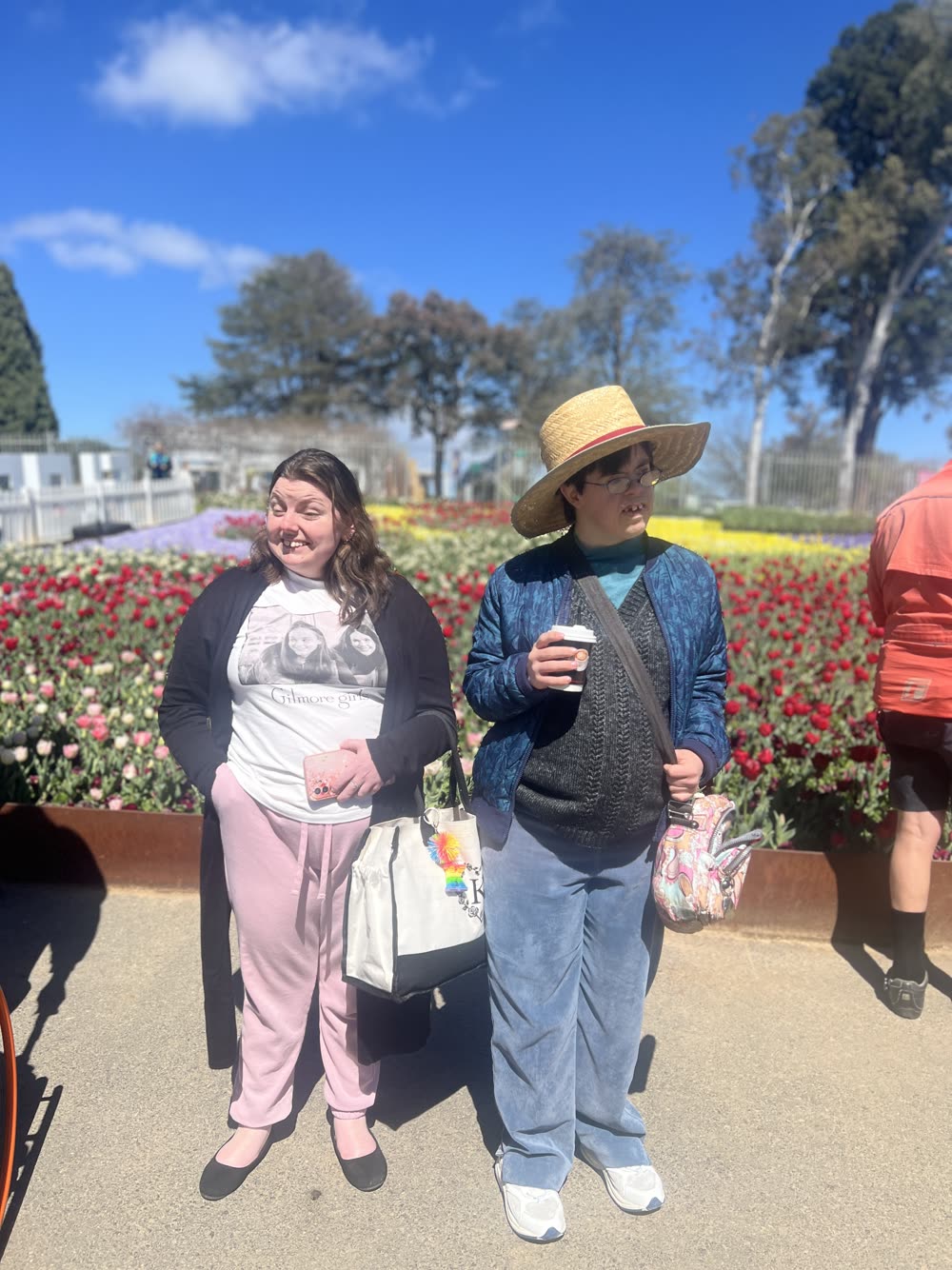 Two people spending time together among colourful flowers in a garden